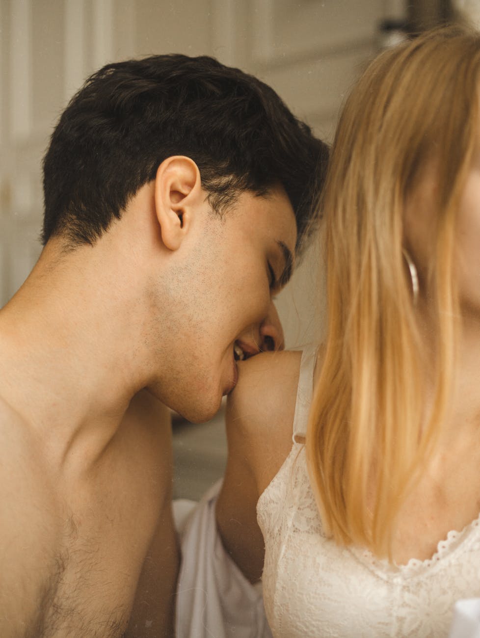man biting the woman s shoulder