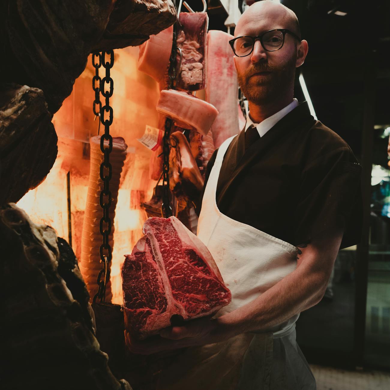 a man holding a slab of meat