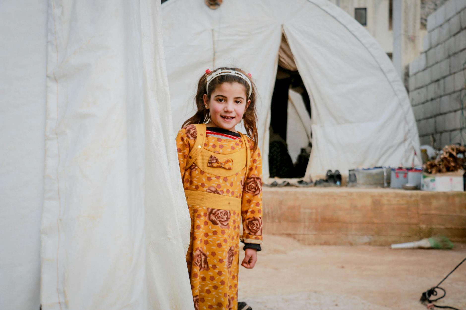 little girl in yellow dress smiling