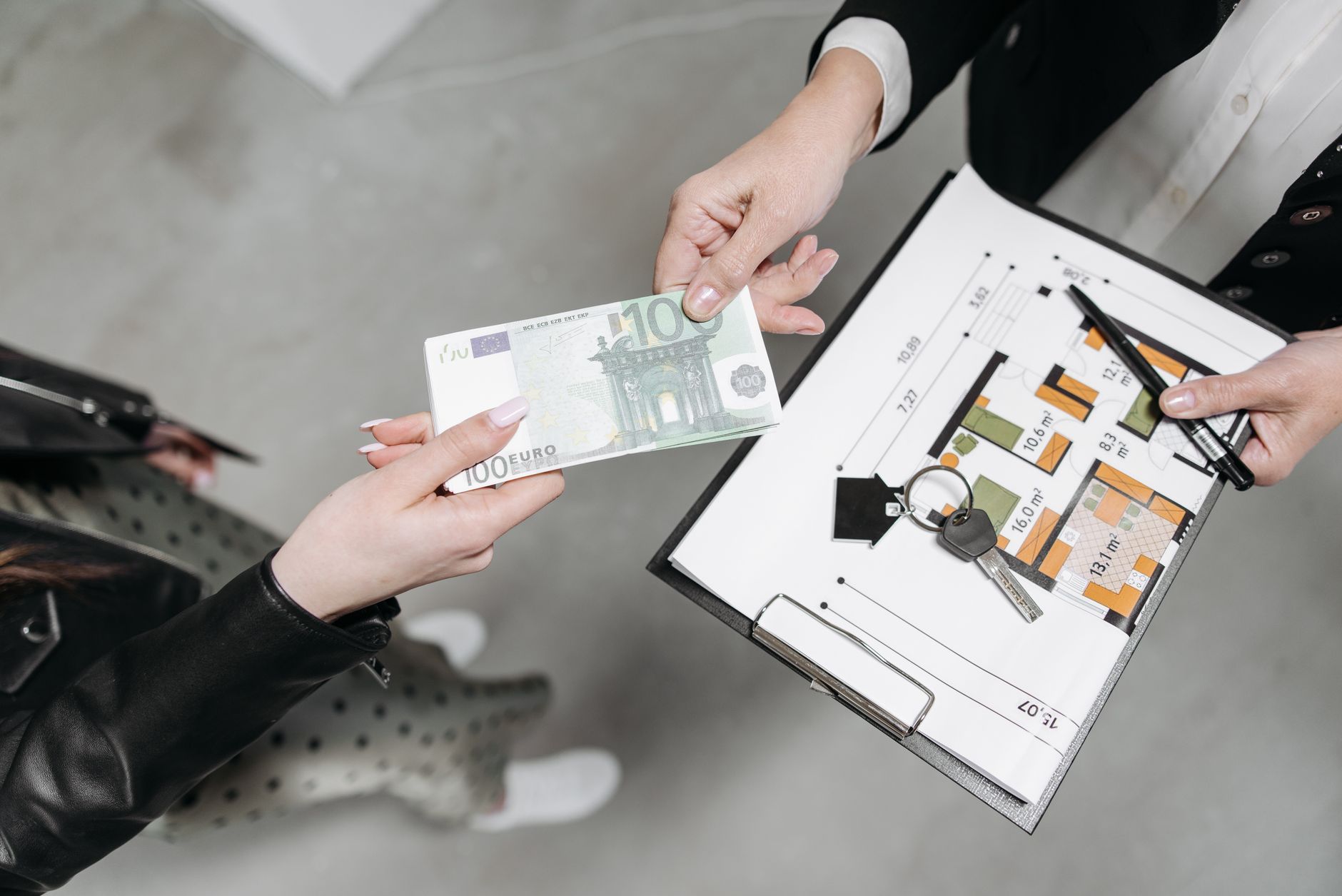 a client handing payment to a realtor