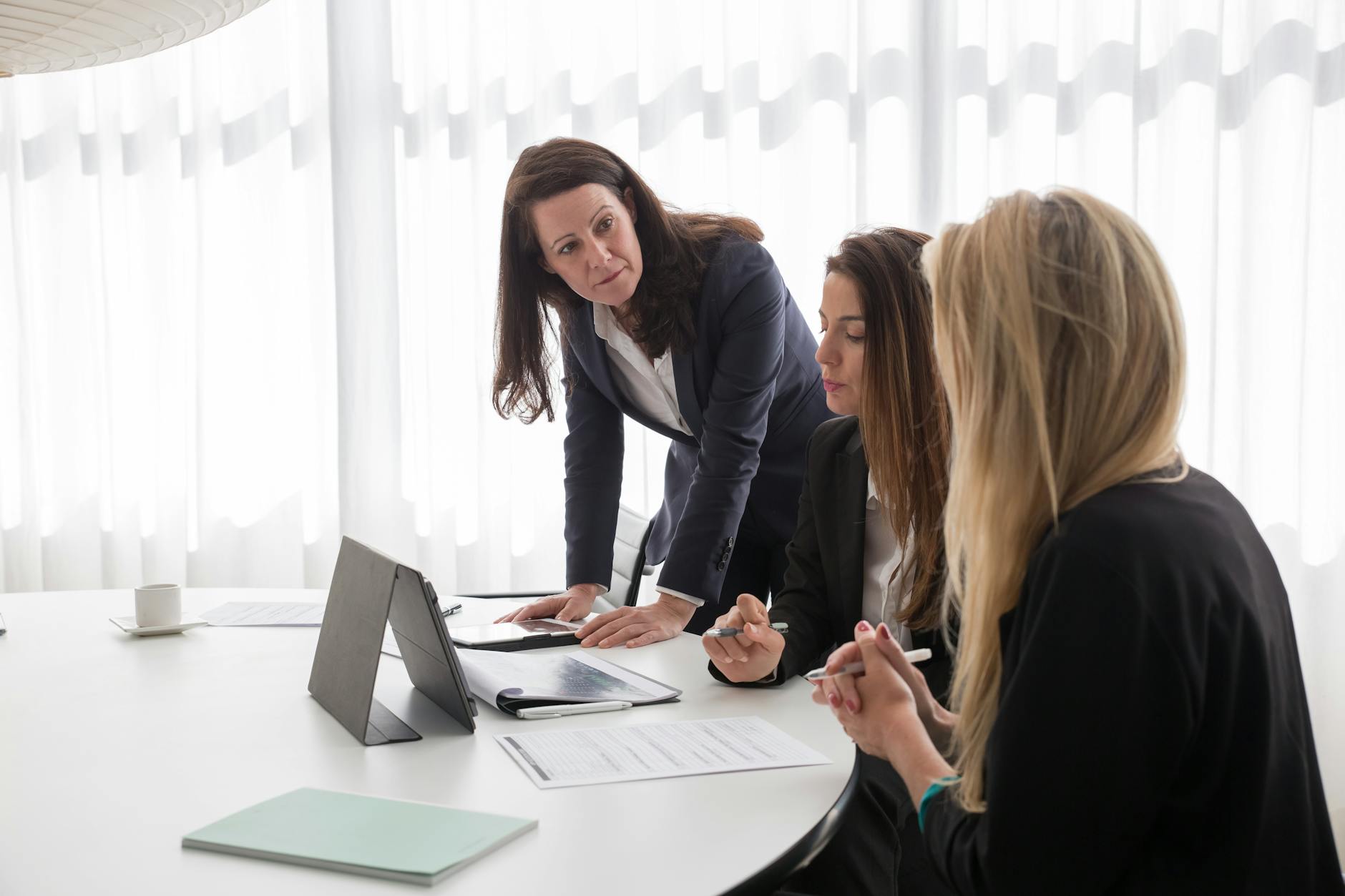 women in blazers working in an office