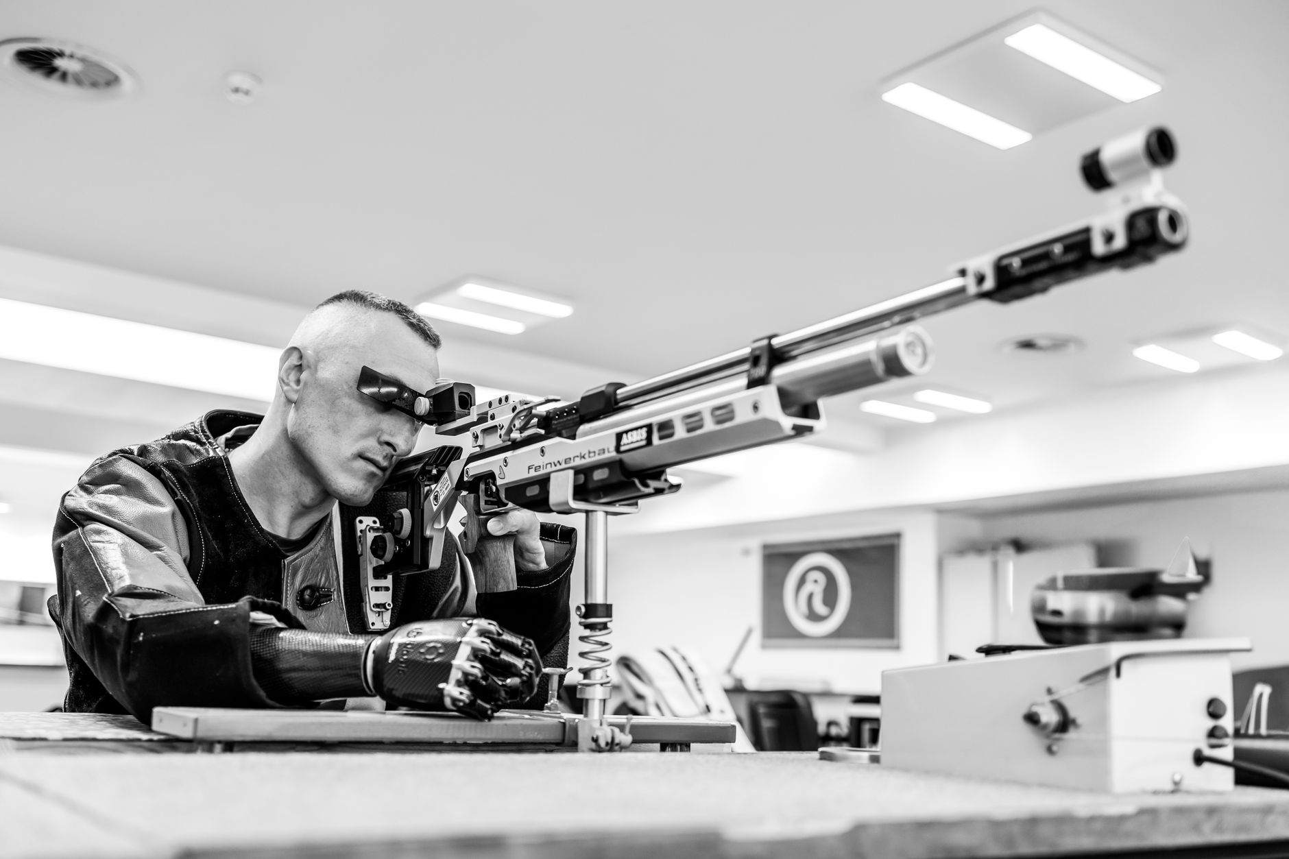 precision air rifle shooter in action indoors
