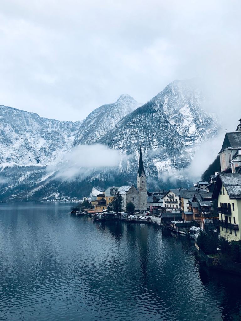 houses near body of water and mountain