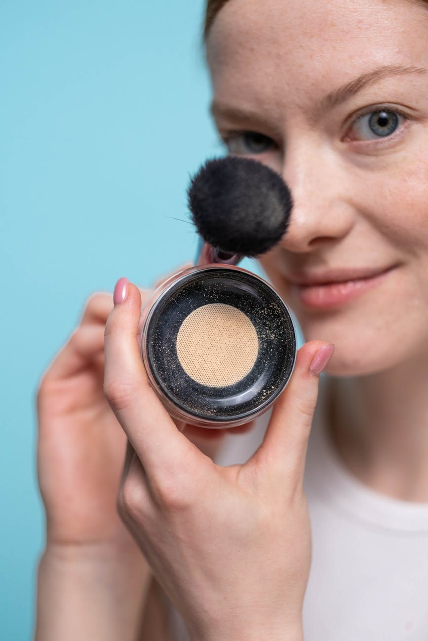 woman holding a single eyeshadow