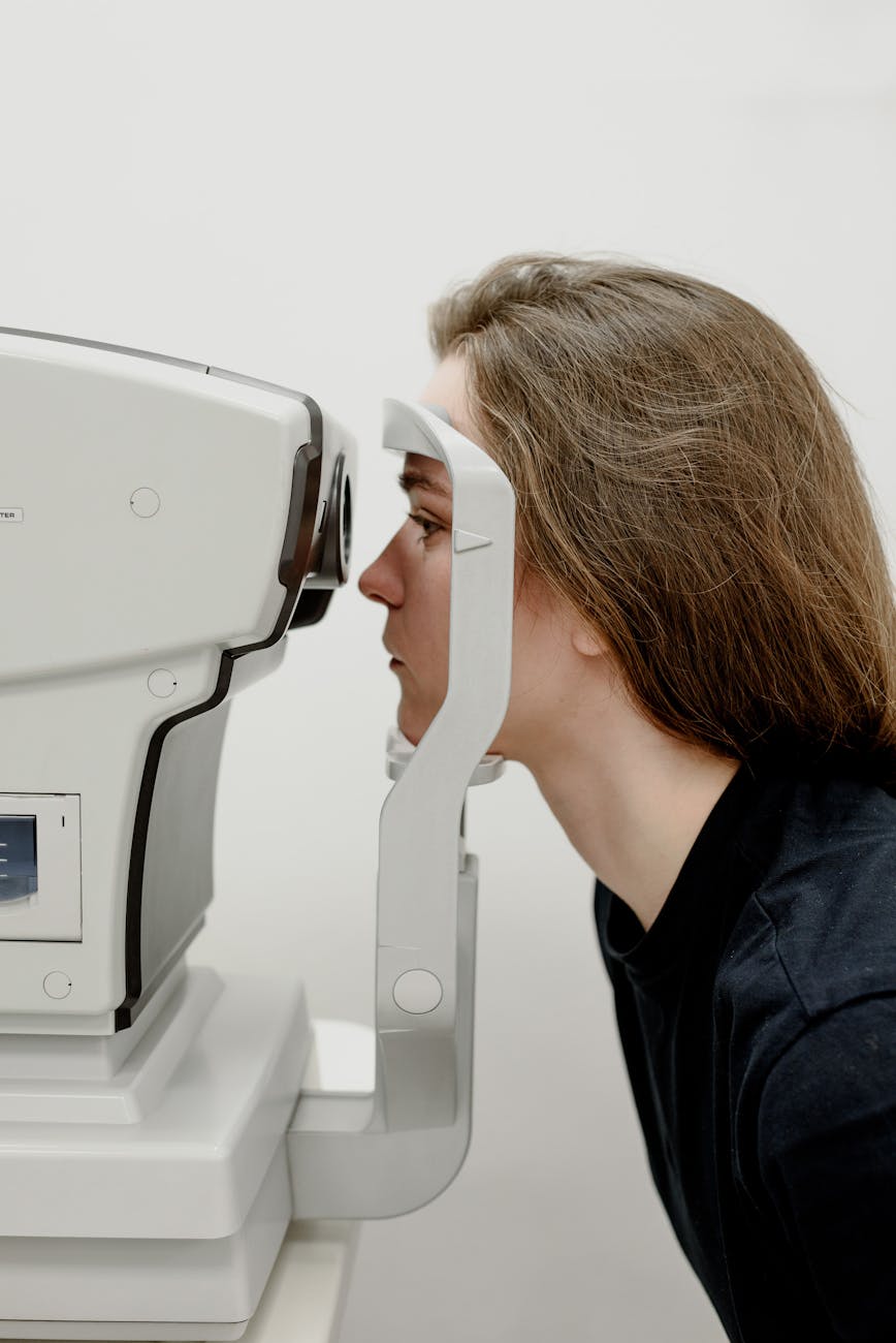 woman examining vision in hospital with modern apparatus